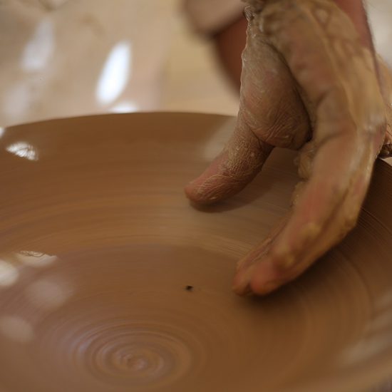 a artist making pottery work, carving a plate using wheels, Shiraz, Iran