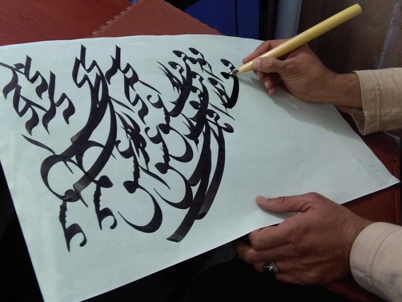 an artist doing calligraphy