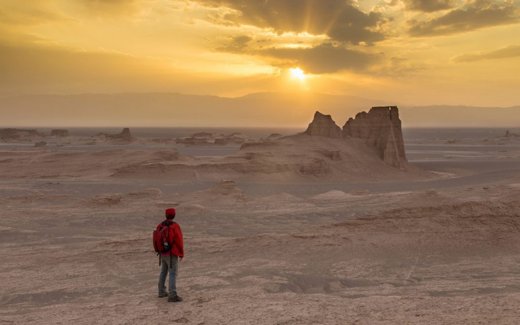 a man looking at shiny sky in Lut Desert