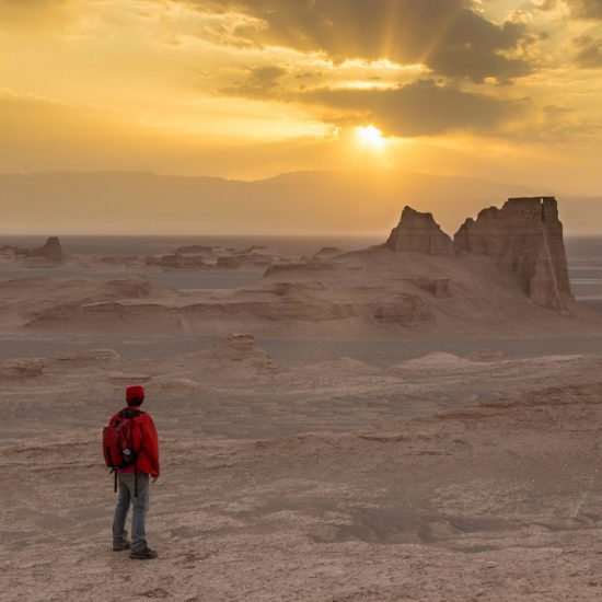 a man looking at shiny sky in Lut Desert