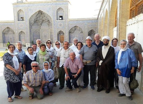 tourist beside Iranian clergy