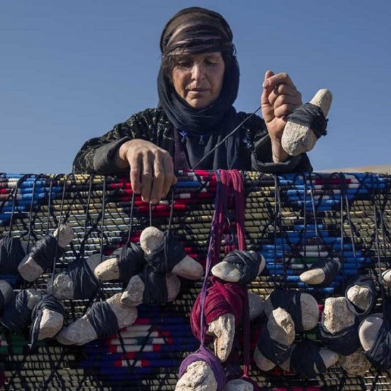 a nomadic woman making handicrafts, nomadic lifestyle,Iran
