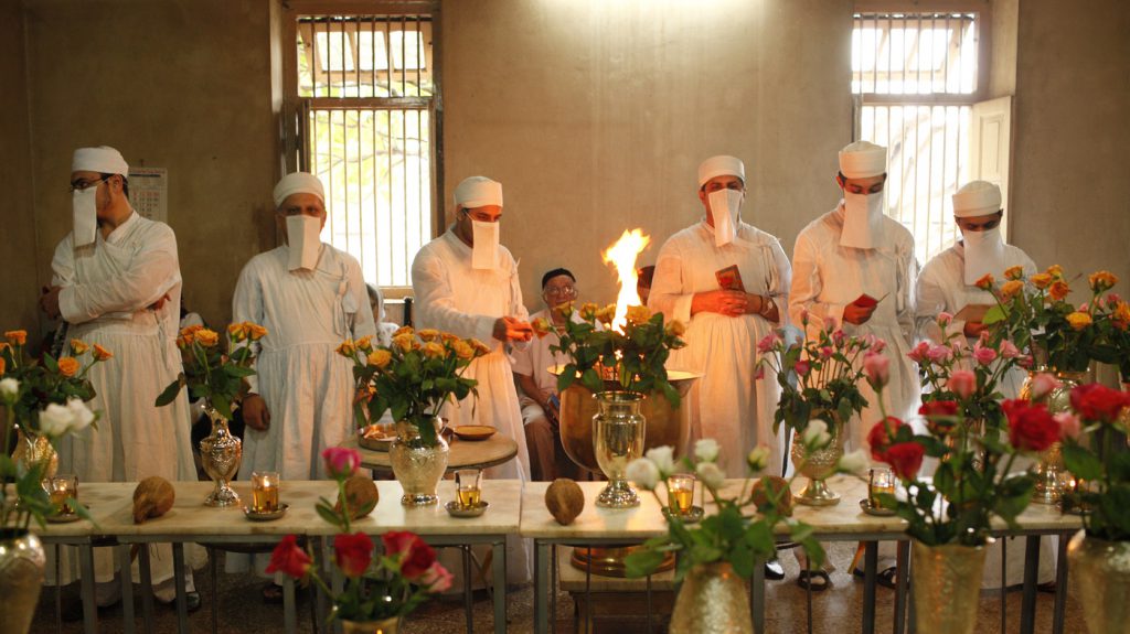 Zoroastrian priests pray to honor the dead inside a temple in Pune, India, on Aug. 18, 2010. Each of the dead is represented by a vase filled with flowers. Parsis forbid images of their funeral ceremonies, where the deceased are taken to the Tower of Silence and consumed by vultures and other birds of prey.